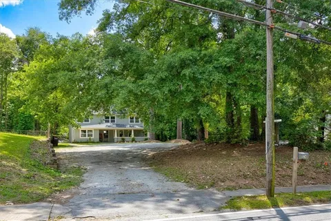 a view of a house with a backyard