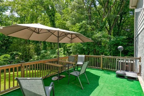 a view of a deck with furniture and a yard