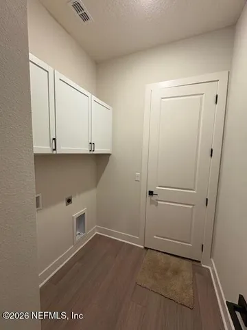 a view of cabinets and wooden floor