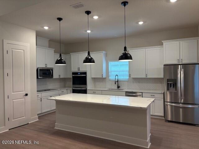 8463 Ford Road Bryceville, FL 32009 - Photo 3 of 14 a kitchen with kitchen island a counter top space appliances and cabinets