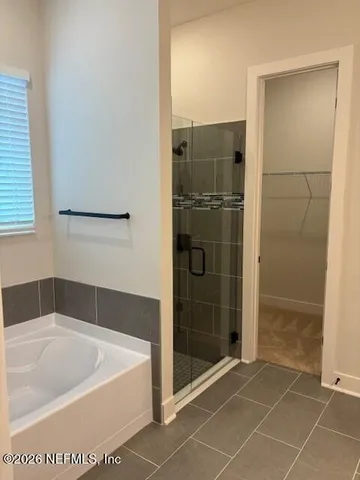 a bathroom with a bathtub and shower