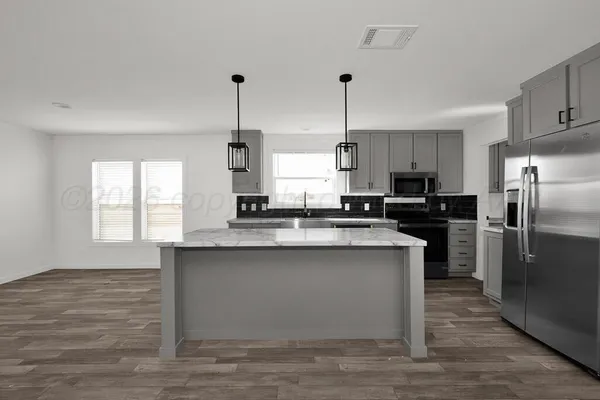 a kitchen with a sink and granite floor window