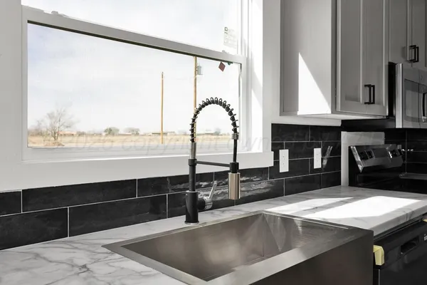 a utility room with granite countertop cabinets washer and dryer