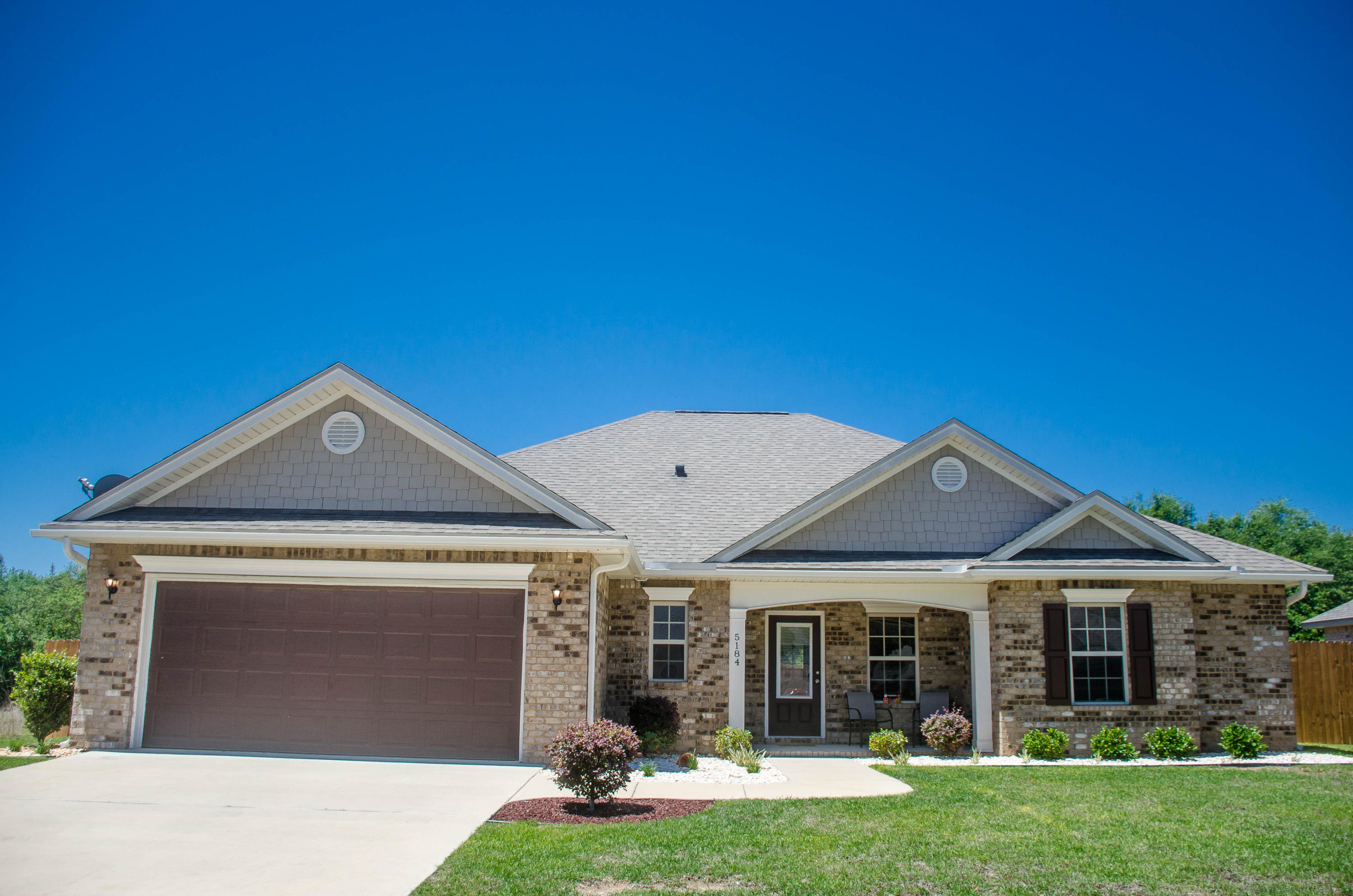 5184 Rabbit Crestview, FL 32539 - Photo 2 of 31 a front view of a house with a yard and garage