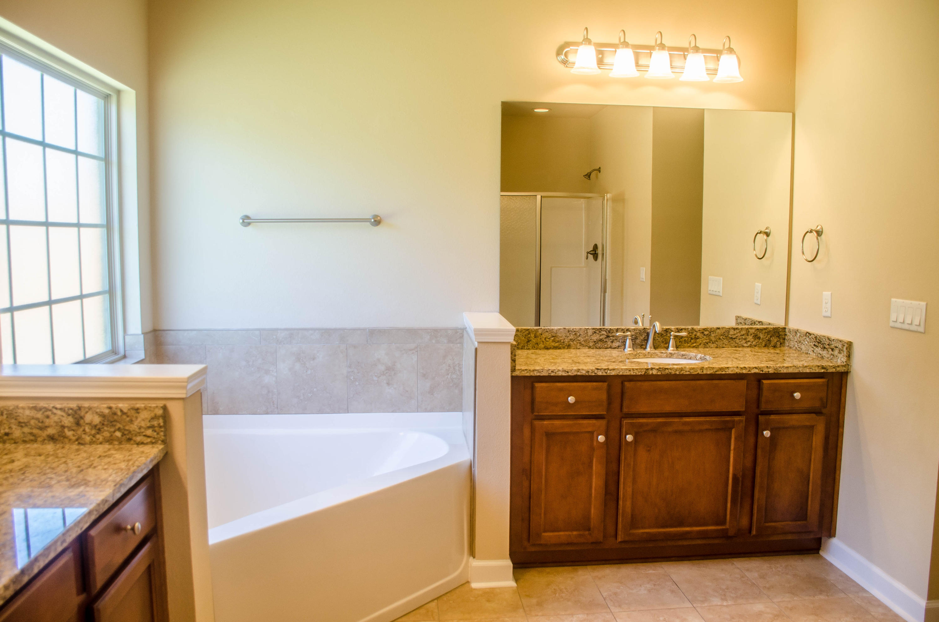 5184 Rabbit Crestview, FL 32539 - Photo 19 of 31 a bathroom with a granite countertop sink a mirror and a bathtub