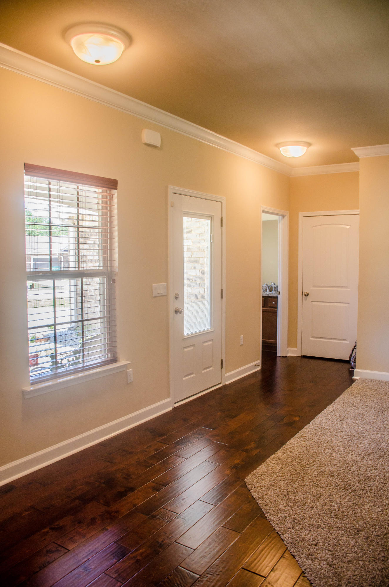 5184 Rabbit Crestview, FL 32539 - Photo 4 of 31 an empty room with wooden floor and windows