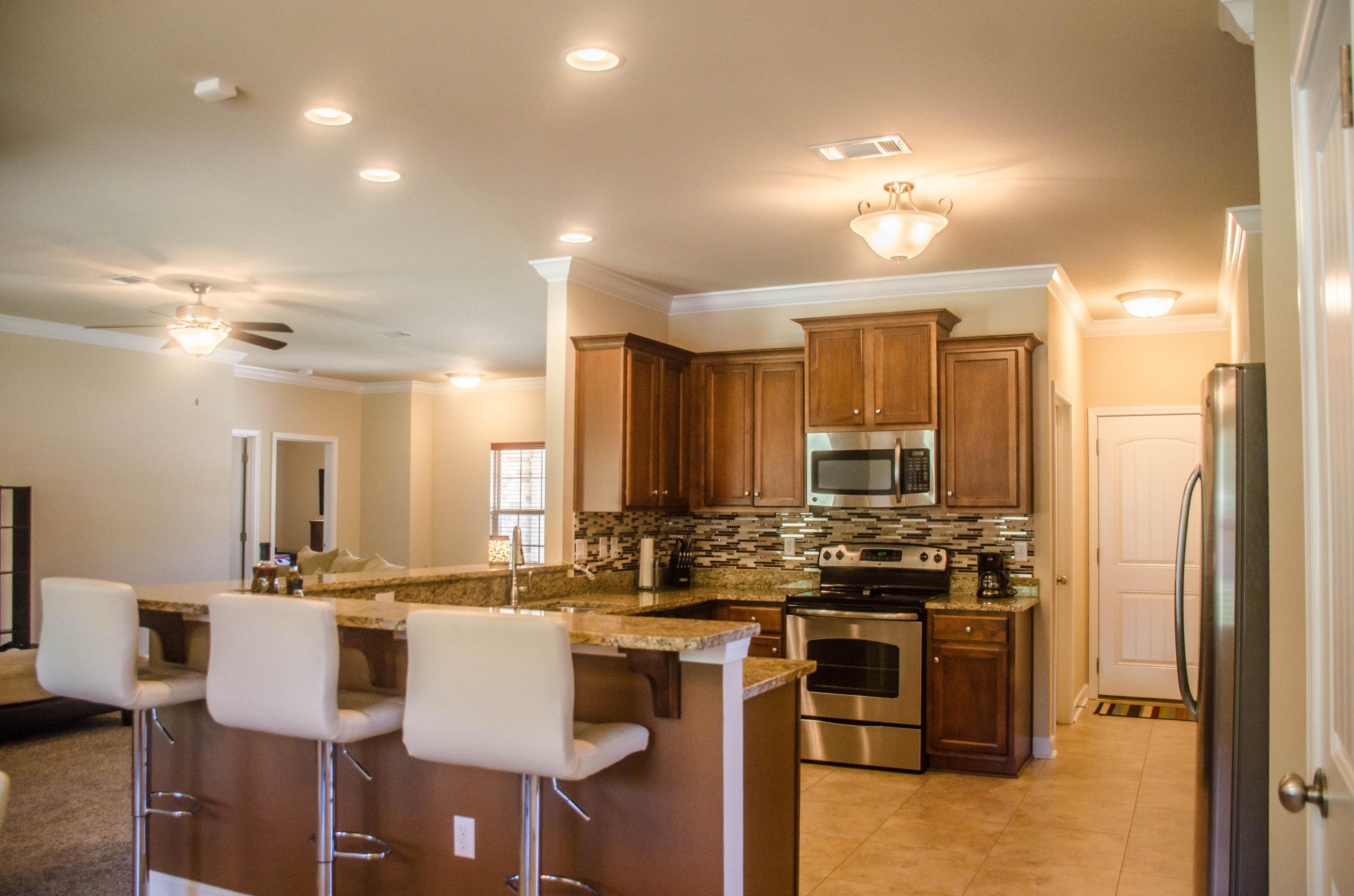 5184 Rabbit Crestview, FL 32539 - Photo 5 of 31 a kitchen with stainless steel appliances granite countertop a stove and a refrigerator