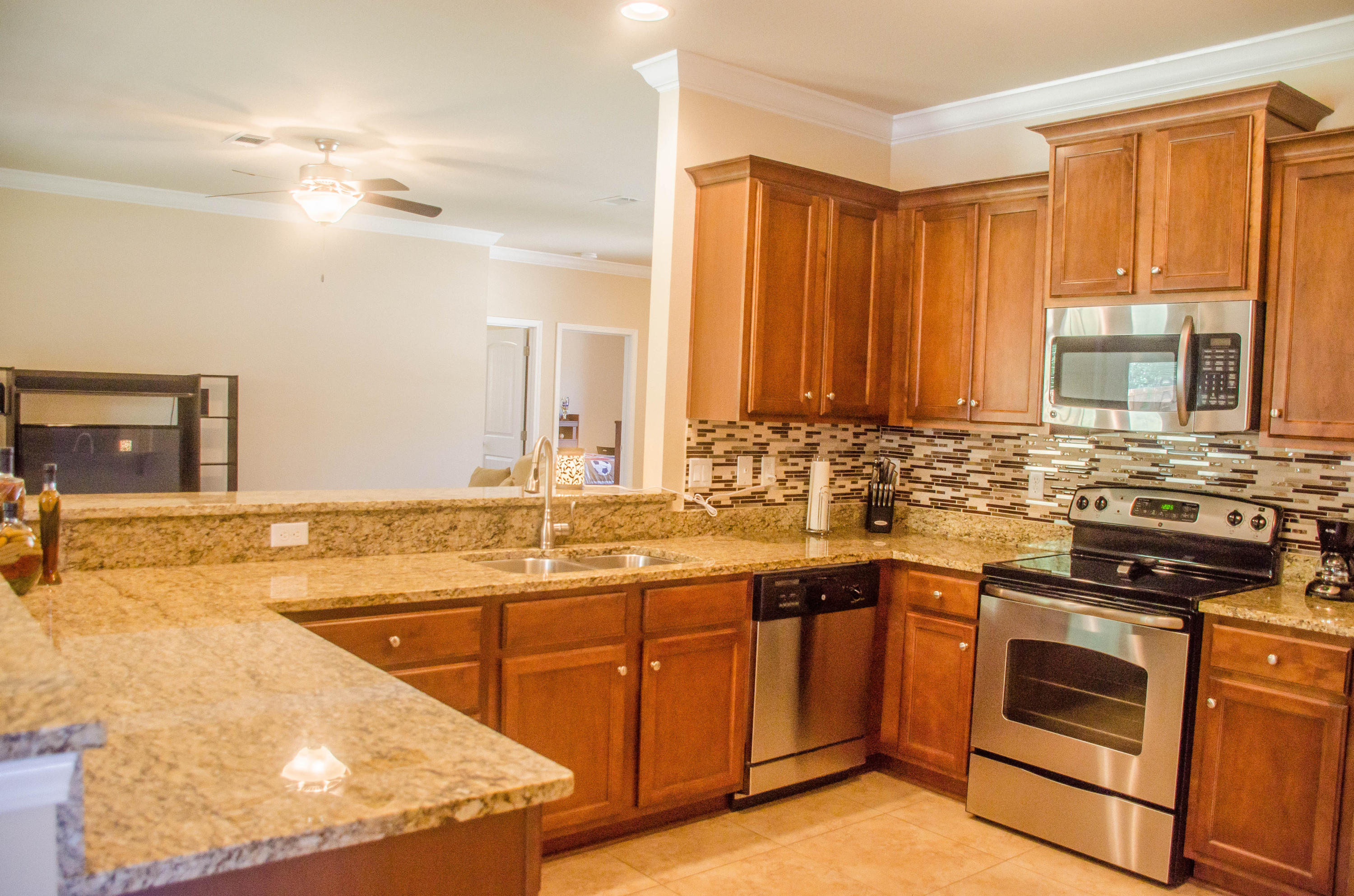 5184 Rabbit Crestview, FL 32539 - Photo 7 of 31 a large kitchen with kitchen island a sink a stove and cabinets