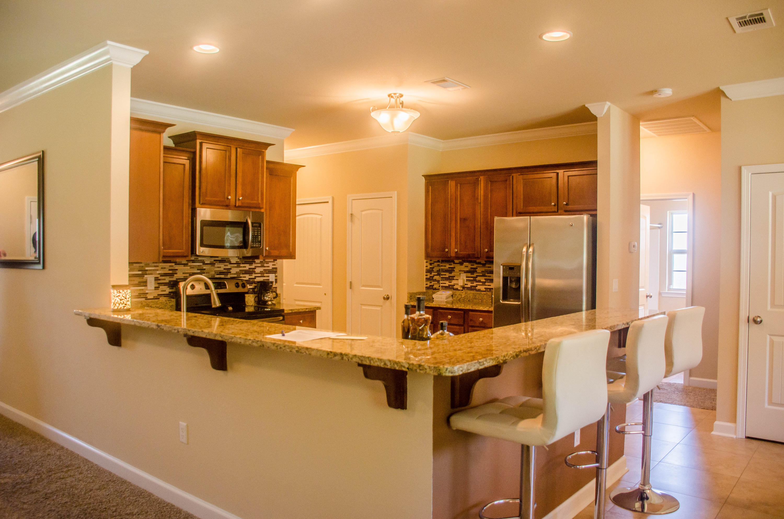 5184 Rabbit Crestview, FL 32539 - Photo 10 of 31 a view of a kitchen with kitchen island granite countertop a sink appliances cabinets and a counter top space