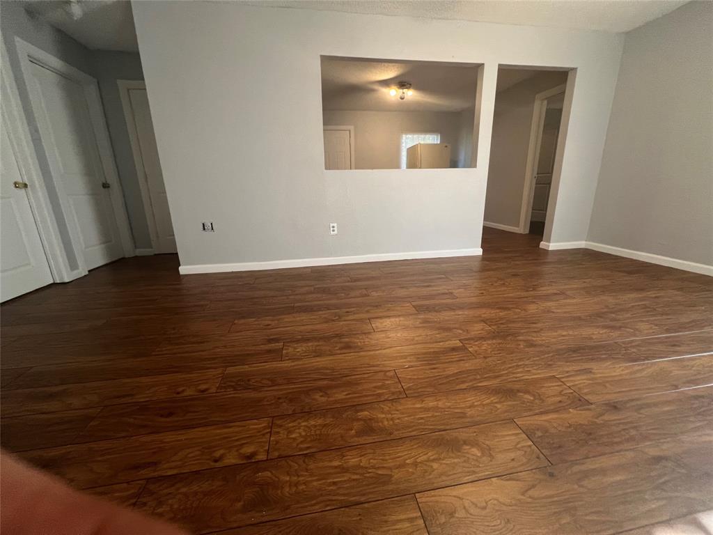 2722 Locust Avenue Dallas, TX 75216 - Photo 13 of 20 a view of a room with wooden floor and door
