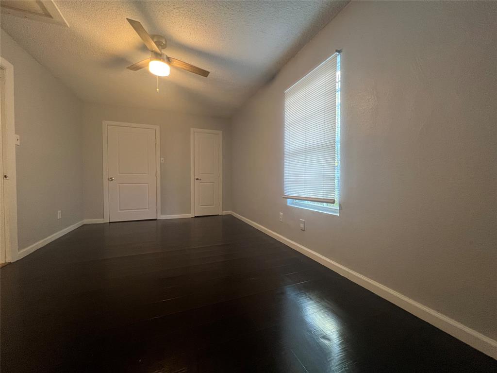 2722 Locust Avenue Dallas, TX 75216 - Photo 16 of 20 an empty room with wooden floor and windows