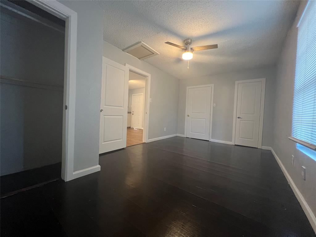 2722 Locust Avenue Dallas, TX 75216 - Photo 17 of 20 an empty room with wooden floor and windows