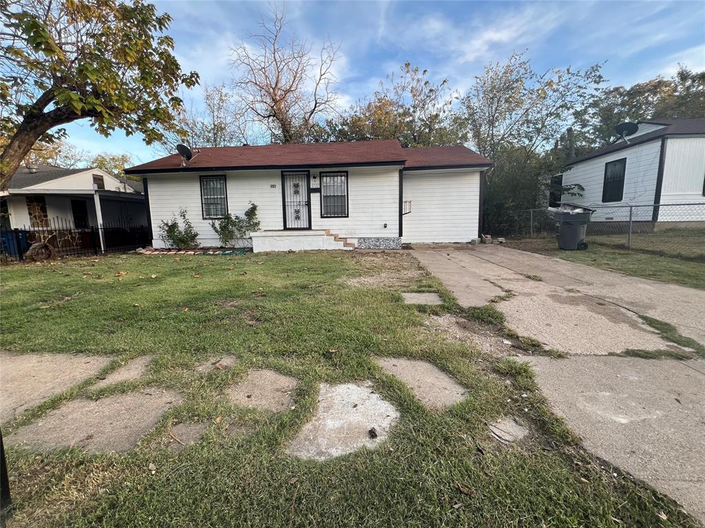 2722 Locust Avenue Dallas, TX 75216 - Photo 19 of 20 a front view of a house with a garden and trees