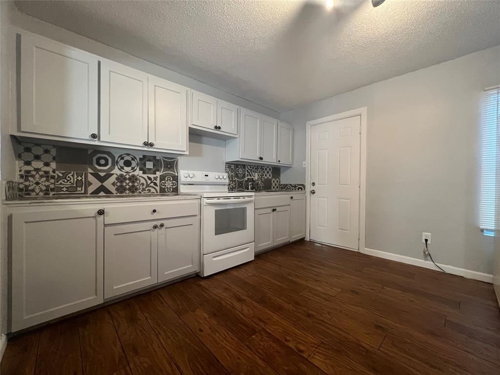 2722 Locust Avenue Dallas, TX 75216 - Photo 4 of 20 a kitchen with a sink cabinets and wooden floor