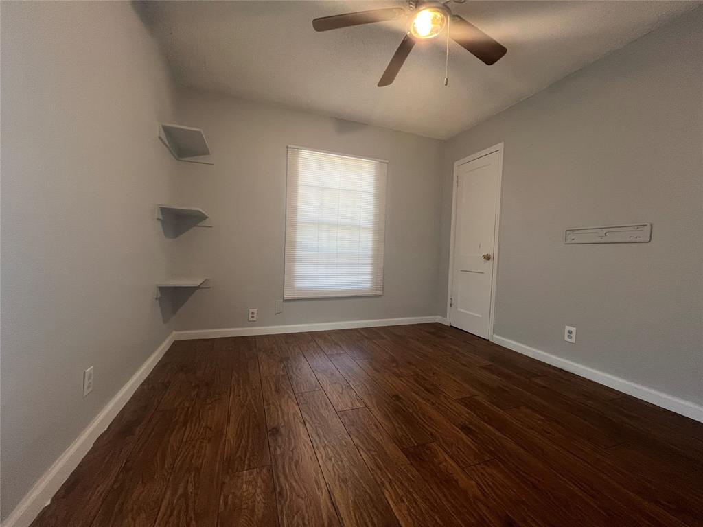 2722 Locust Avenue Dallas, TX 75216 - Photo 9 of 20 wooden floor in an empty room with a window