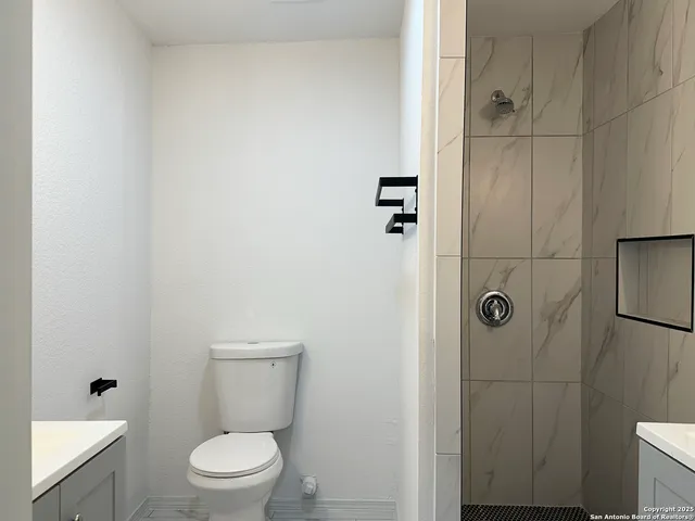 a white toilet sitting next to a bathroom sink