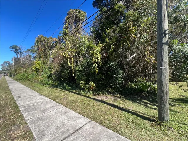 a view of a street with a yard