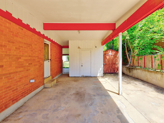 1272 Cook Street Ogden, UT 84404 - Photo 3 of 58 Covered concrete patio featuring a brick exterior wall, painted wood siding, red support beams, and an exterior storage shed