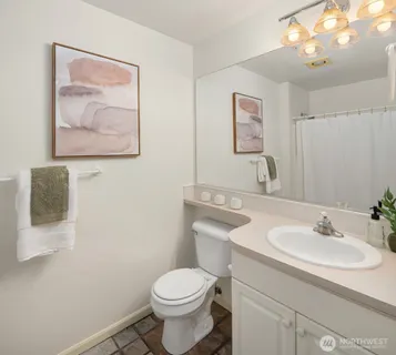 a bathroom with a toilet a sink and mirror