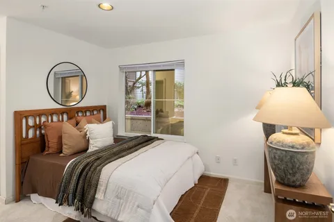 a bedroom with a bed and a window