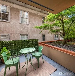 a view of a patio with table and chairs and potted plants