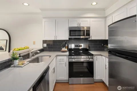 a kitchen with a sink stove and microwave