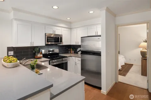 a kitchen with a refrigerator and a stove top oven
