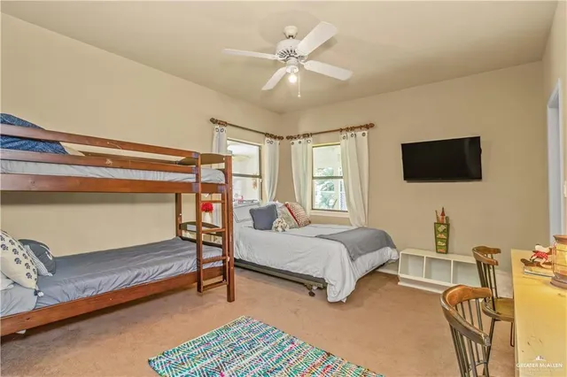 a bedroom with furniture and a flat screen tv