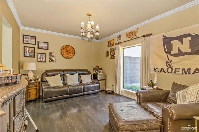 a living room with furniture and a chandelier