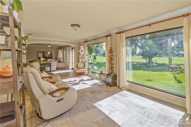 a living room with furniture and large windows