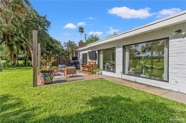 a view of a house with backyard porch and sitting area