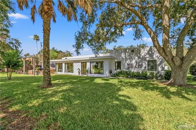 a front view of a house with yard and green space