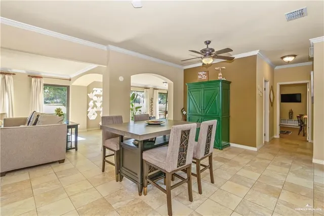a dining room with furniture a chandelier and window