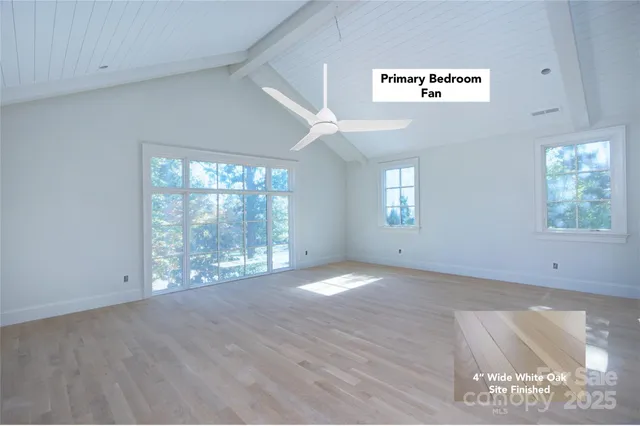 a view of a kitchen with wooden floor and a window