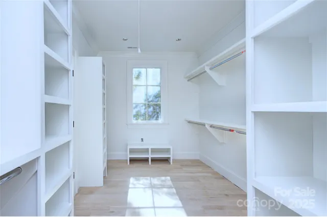 a view of a kitchen with white cabinets