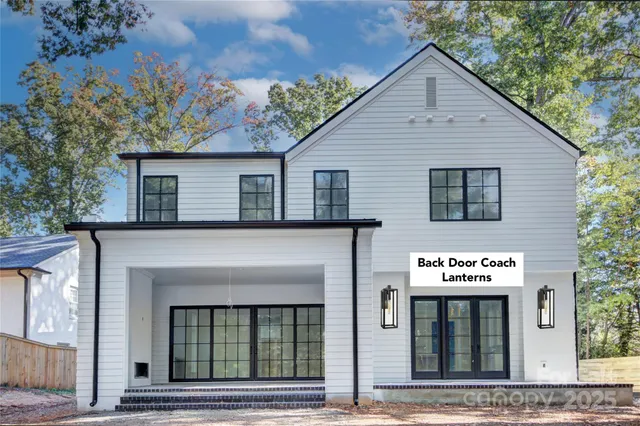 a view of a house with entryway and a tree