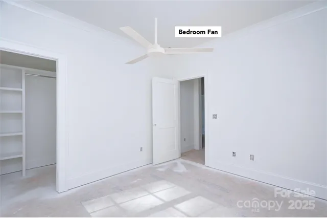 a view of a livingroom with a ceiling fan and window