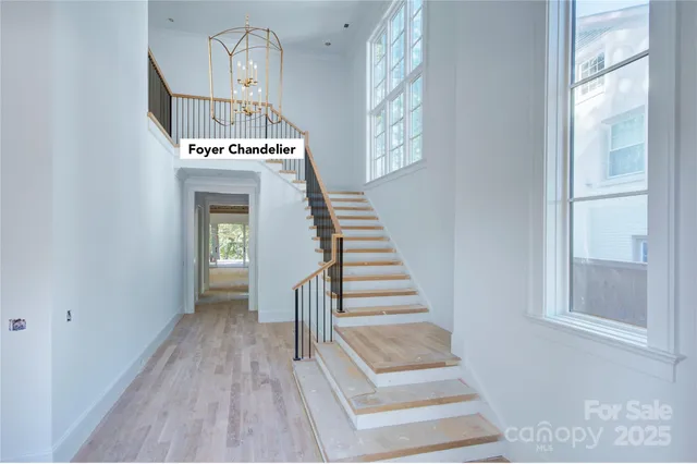 a view of a house with a balcony and trees in the background