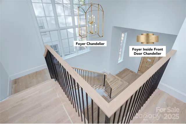 a view of kitchen with stainless steel appliances wooden floor and large window