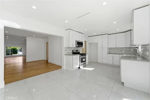 a view of kitchen with refrigerator and cabinets