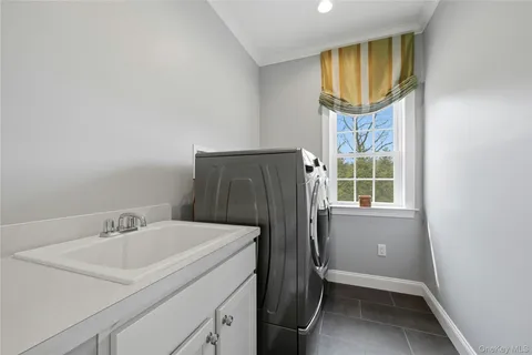 a bathroom with a sink a mirror and a window