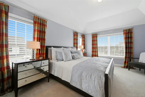 a bedroom with a bed chair and a window