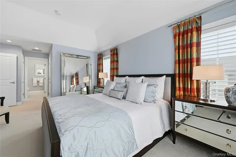 a large bedroom with a bed and window