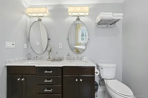 a bathroom with a toilet a sink and a mirror