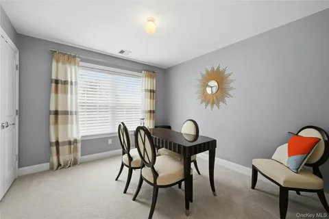 a dining room with furniture and chandelier