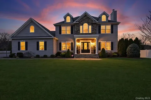 a front view of a house with a garden and yard