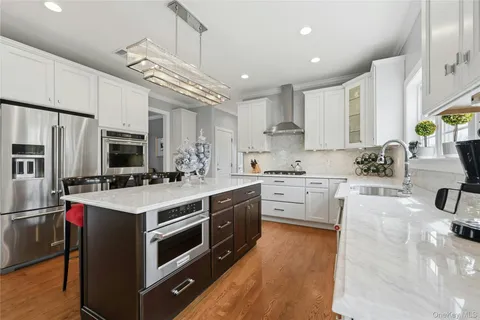 a kitchen with stainless steel appliances a stove sink microwave and cabinets
