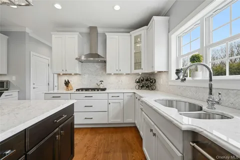 a kitchen with a sink stove and cabinets