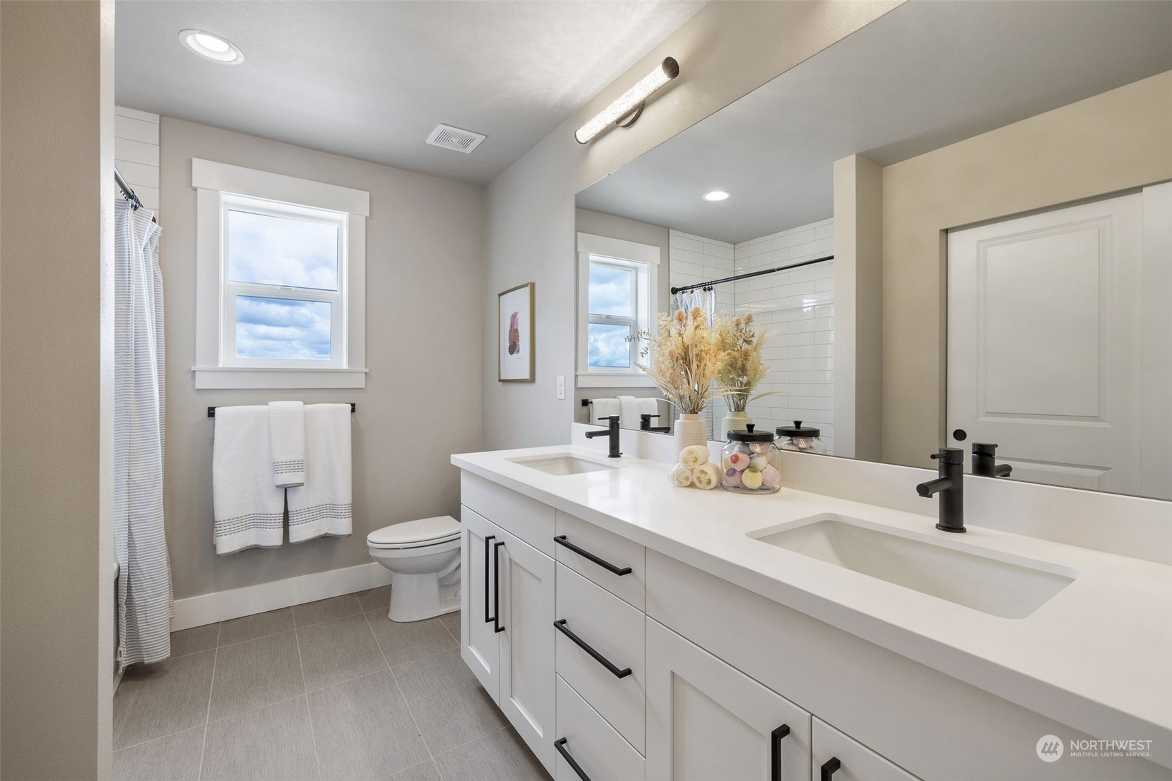18427 1st Avenue Southeast Bothell, WA 98012 - Photo 8 of 13 a bathroom with a double vanity sink toilet and a mirror