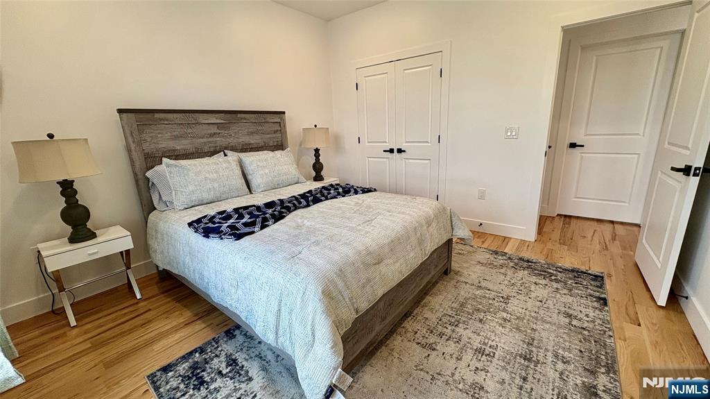 367 Devon Street, Unit 2 Kearny, NJ 07032 - Photo 22 of 30 a bedroom with a bed and a mirror